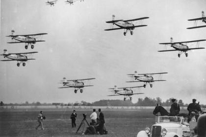 Multiple aircraft fly in formation at the National Air Races held in Cleveland, July 1935.