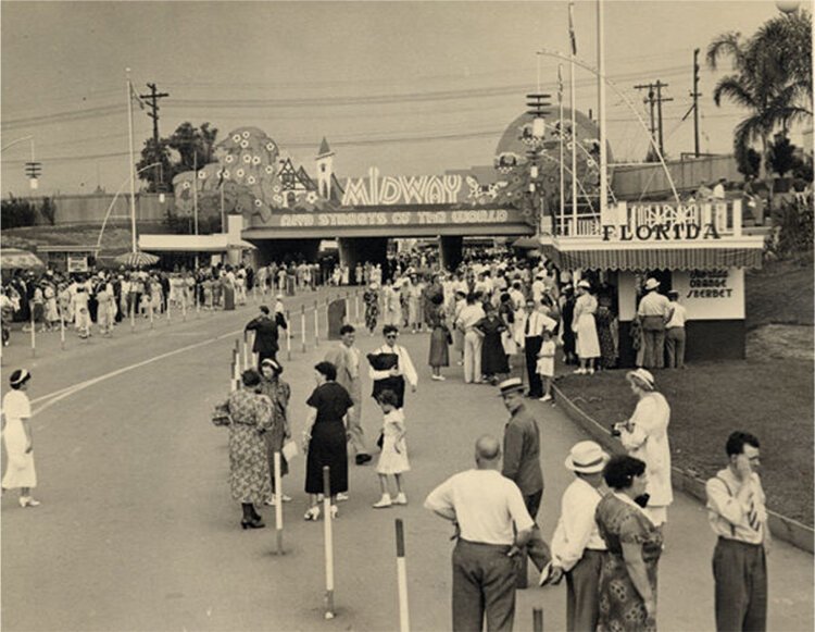 Crowds at the entrance to the Midway and the Streets of the World Exhibit at the Great Lakes Exposition, Florida Orange Sherbet booth in foreground.
