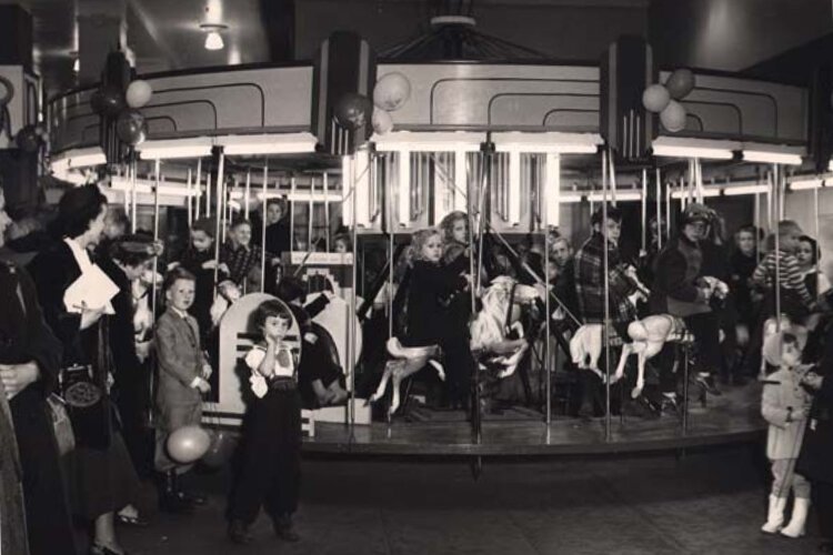 Children riding an indoor carousel, Sterling-Lindner-Davis department store1949