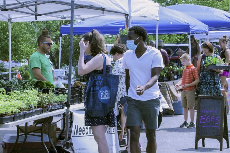 Andrew Needham, the director of Needham Gardens, sells produce at Kamm’s Corners Farmers Market in Cleveland’s West Park neighborhood. 