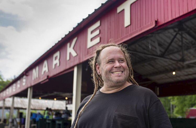 Kevin Scheuring, the manager at Coit Road Farmers Market in East Cleveland, stands in front of the 100-year-old market where residents buy fresh produce from urban farmers. About half of the sales coming into the market are from incentive programs, w