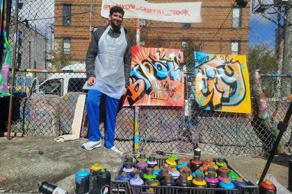 Daniel Seddiqui working on graffiti in Brooklyn