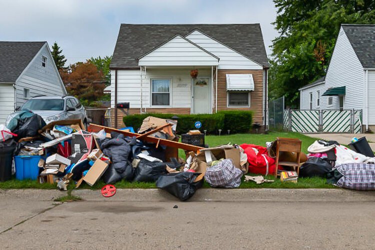 An evicted house at a suburban street with left belongings in the city of Detroit.