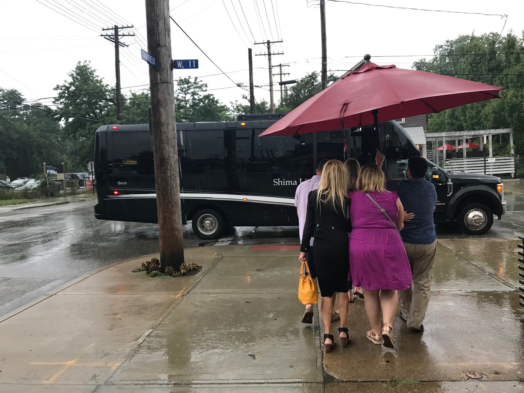 Now that's service—using a patio umbrella to escape the rain