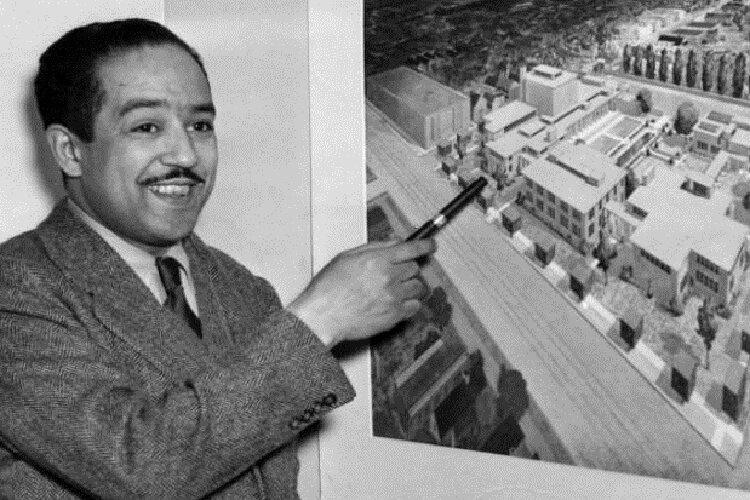 Langston Hughes showcasing the original plans for the Karamu House building in 1945,