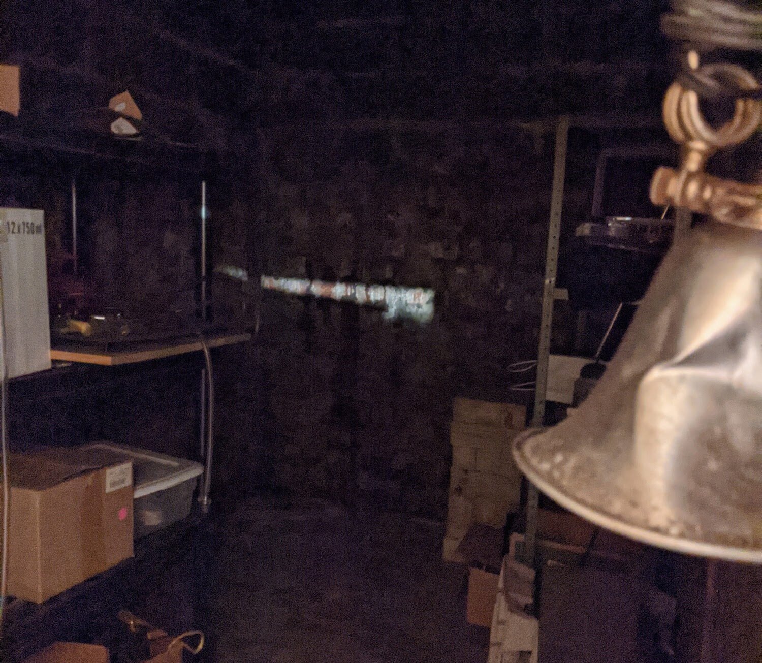 A ghostly visage looms in a crack of light.